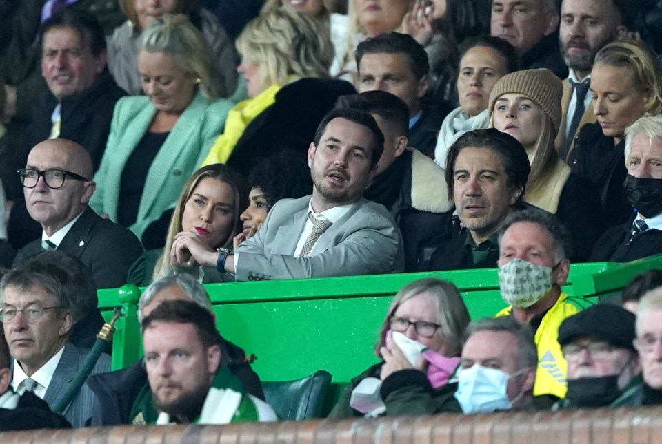 Actor Martin Compston in the stands at a soccer match.