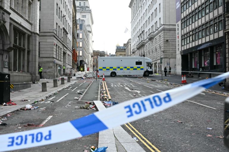 Police officers stand at a cordon on in Water Street in Liverpool, north-west England on May 27, 2025, after a car ploughed in to crowds gathered to watch an open-top bus victory parade for Liverpool's Premier League trophy parade.