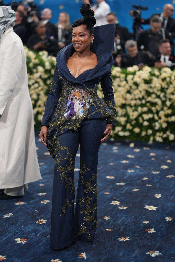 Regina King is wearing a navy suit with bespoke details.