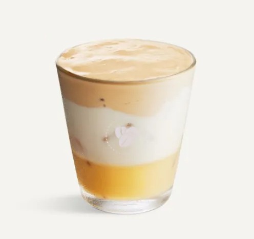 White chocolate iced whipped latte in a glass.