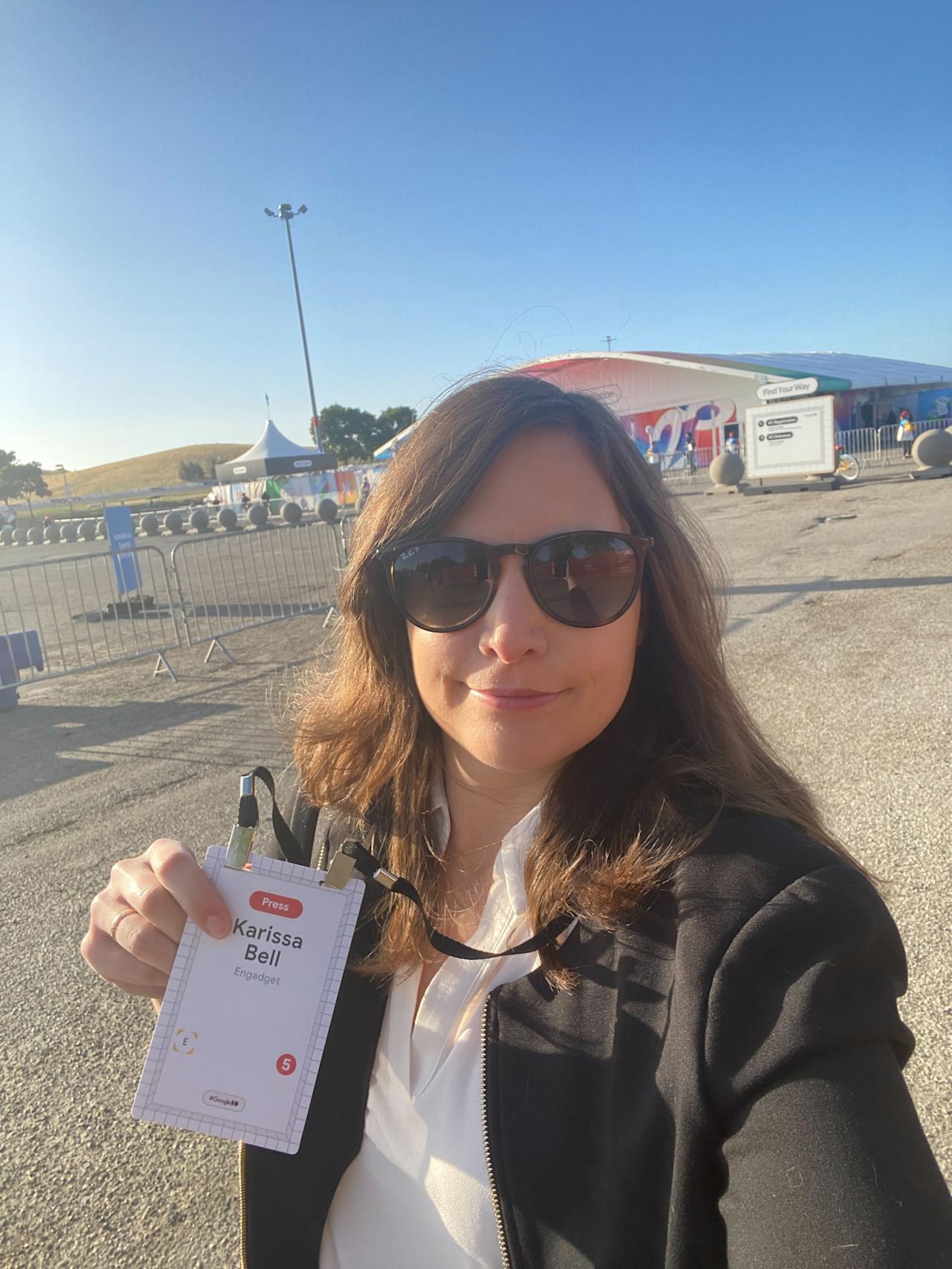 A woman holding up a badge that says 
