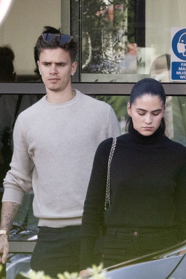 Romeo Beckham and Kim Turnbull arriving at an airport.