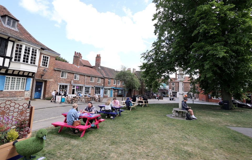 Tourists and locals enjoying a sunny day in York, England.
