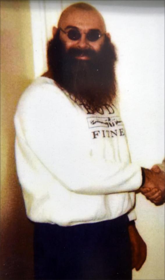 Photo of Charles Bronson, a British criminal, wearing a white sweatshirt and sunglasses.