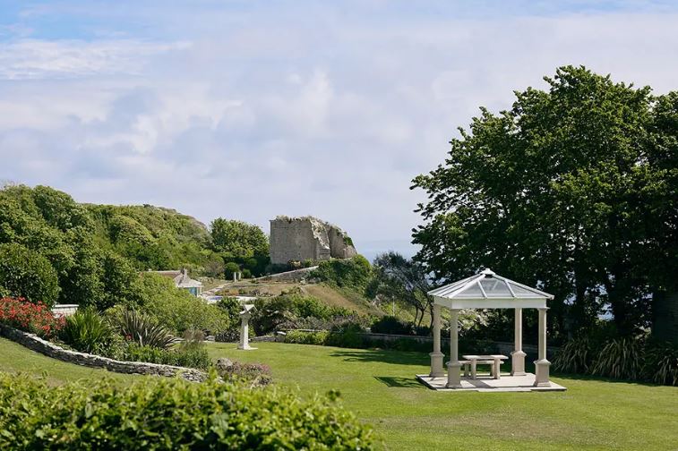 Wyatt Castle viewed from a garden with a gazebo.