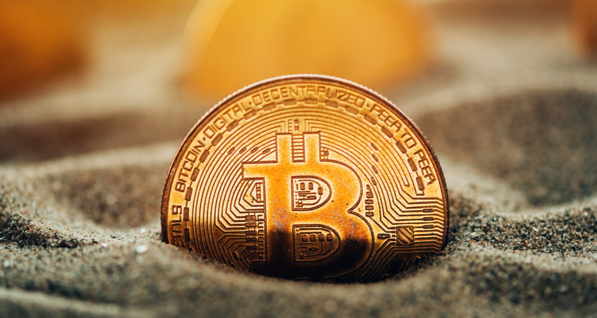 Bitcoins in sand