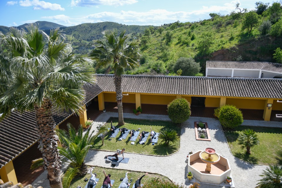 Yoga class outdoors in a courtyard.