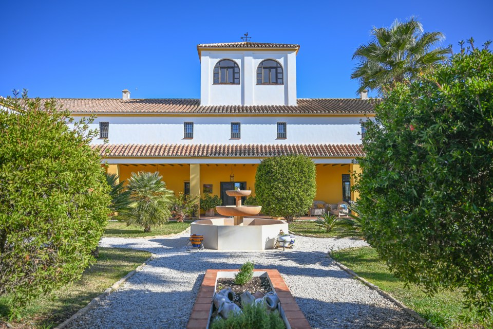 Courtyard of a Spanish-style building with a fountain.