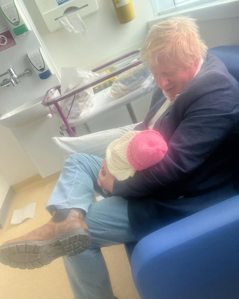 Boris Johnson holding his newborn baby.
