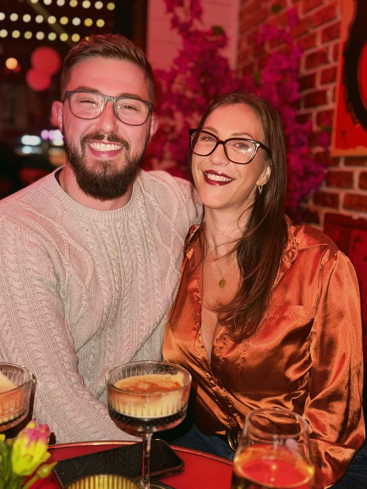 Newlyweds sitting together at a bar.