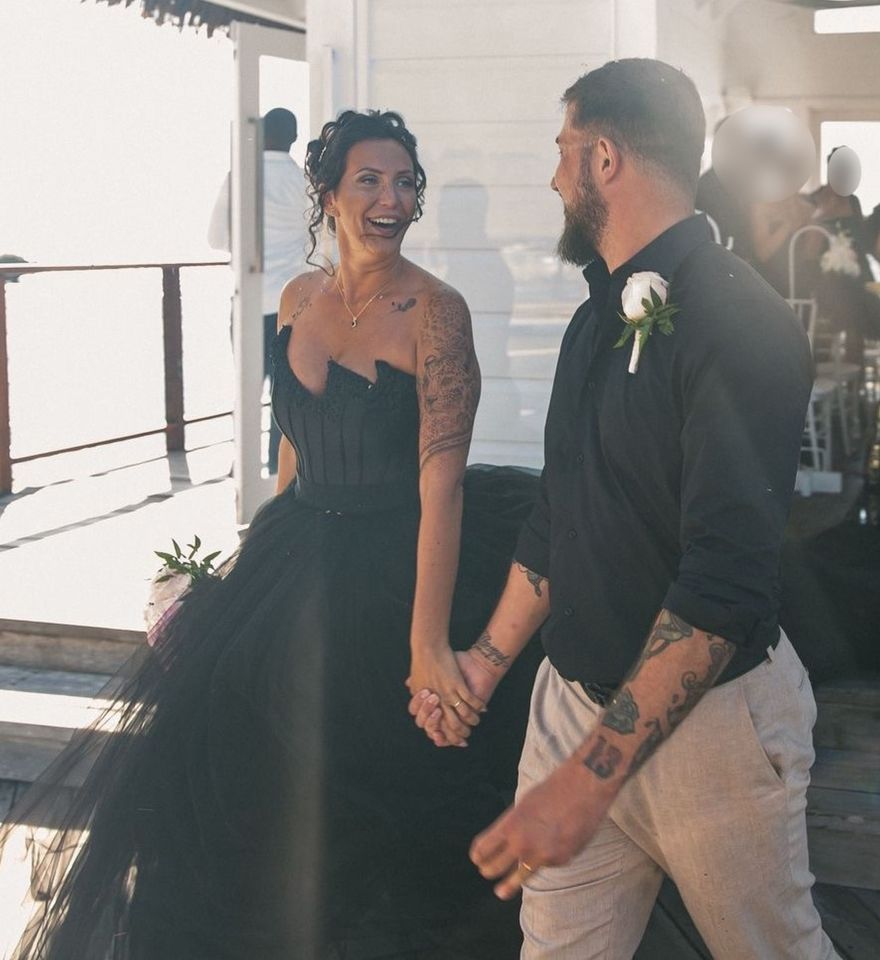 A bride and groom holding hands on their wedding day.