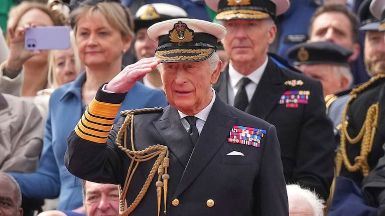 Britain's King Charles III salutes as he watches the V-E Day 80th anniversary parade in London