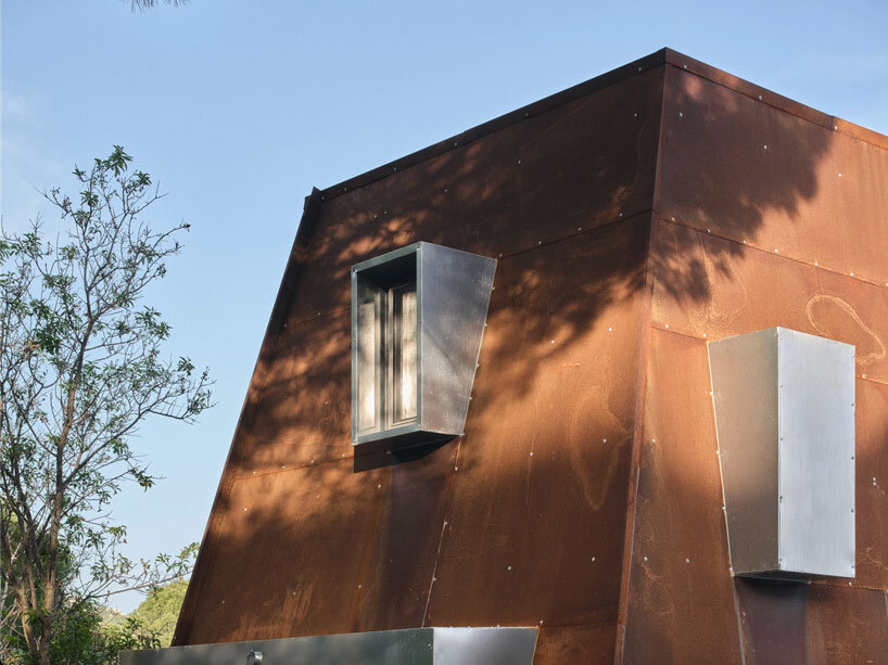 corten steel angular cabin emerges amongst pergamon forests in turkey