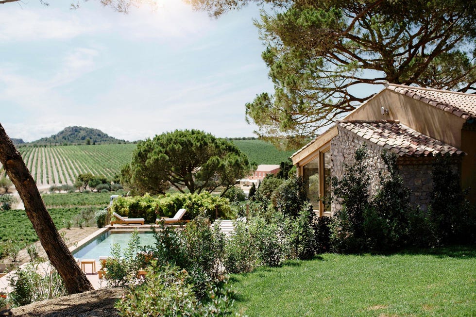 a house with a pool and trees