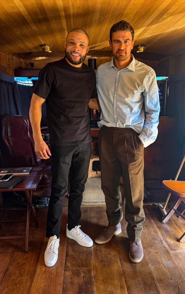 Chris Eubank Jr. and another man posing for a photo on a film set.