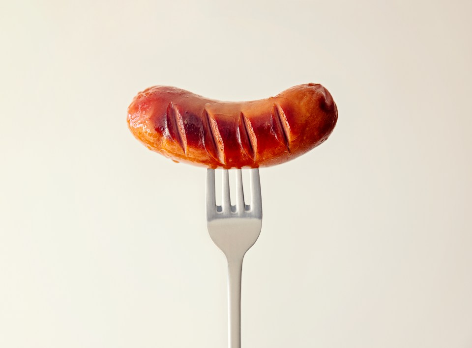 Grilled sausage on a fork.