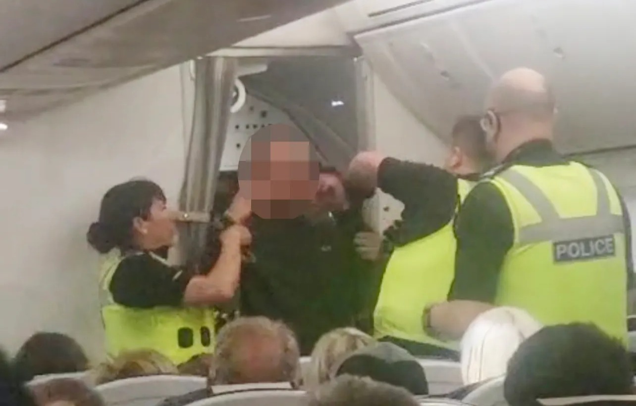 Moment ‘drunk’ passenger hauled off TUI flight by cops after PUNCHING cabin crew & screaming ‘plane's going to crash’