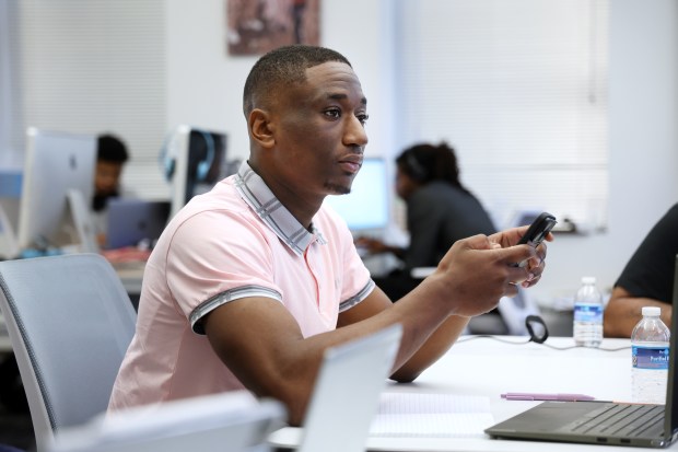 Jeremiah Swint works as a loan officer at Male Mogul Initiative. (Terrence Antonio James/Chicago Tribune)