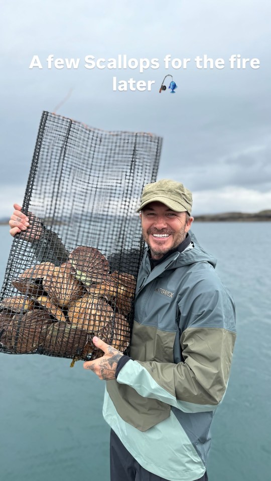 Man holding a net full of scallops.