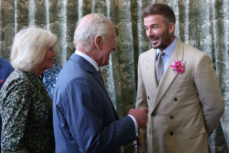 David Beckham speaking with King Charles III and Queen Camilla.