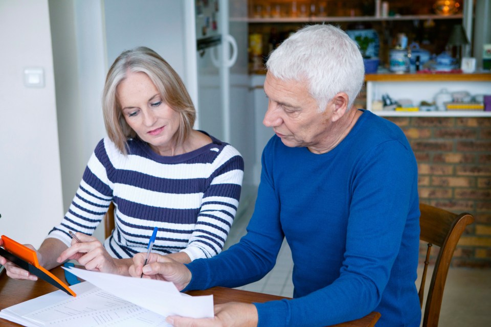 A senior couple reviewing paperwork together.