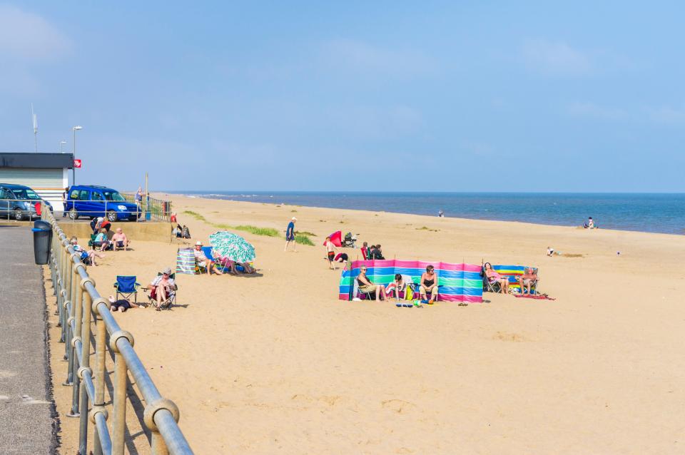 People relaxing on a sandy beach.