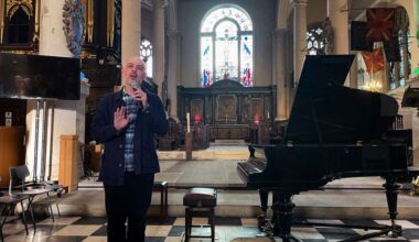 Russian film maker Roman Liberov addresses the audience at a concert he organised in memory of Pavel Kushnir, in London