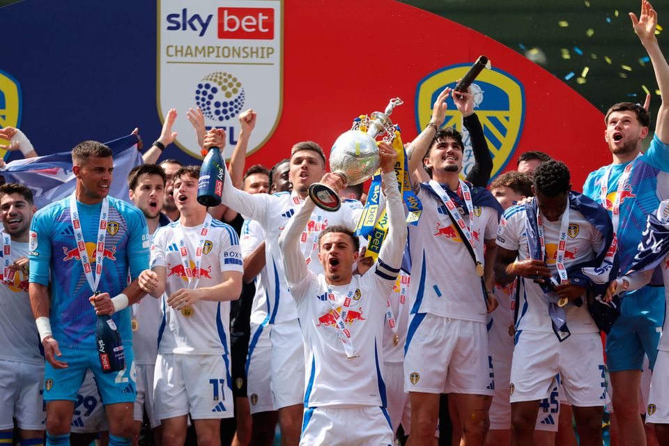 Leeds United's Ethan Ampadu and team-mates celebrate with the trophy after being crowned champions following the Sky Bet Championship match at Home Park, Plymouth