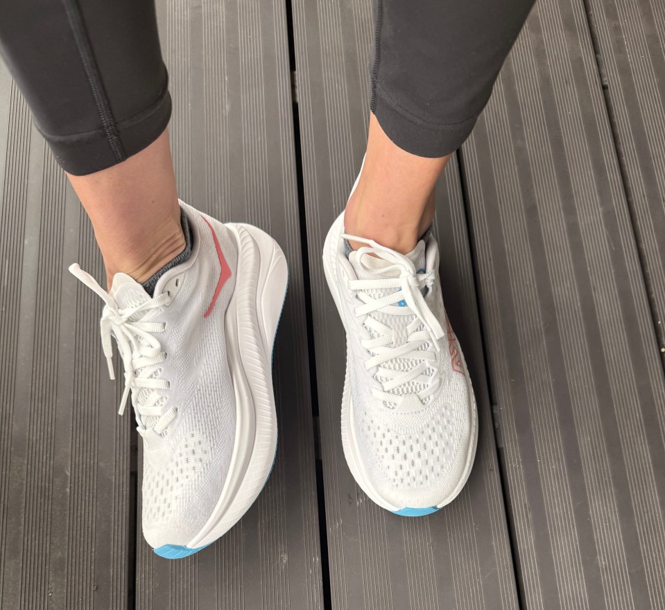 Pair of white athletic shoes with light blue accents.