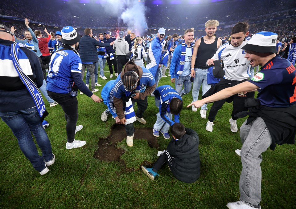 Fans celebrating on a soccer field, ripping up the turf.
