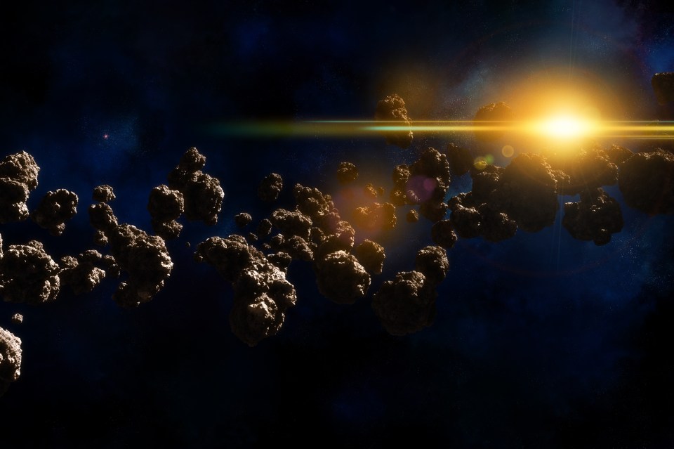 Illustration of asteroids in space with a bright star.