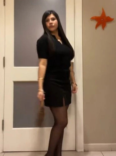 Woman in black dress and tights.