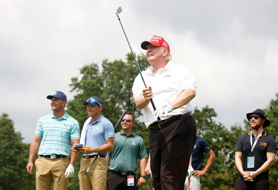 Donald Trump taking a golf shot during a pro-am.