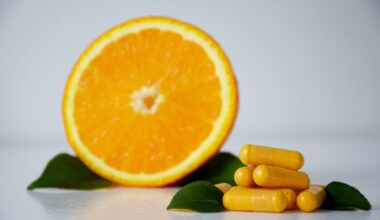 Vitamin C capsules with an orange.