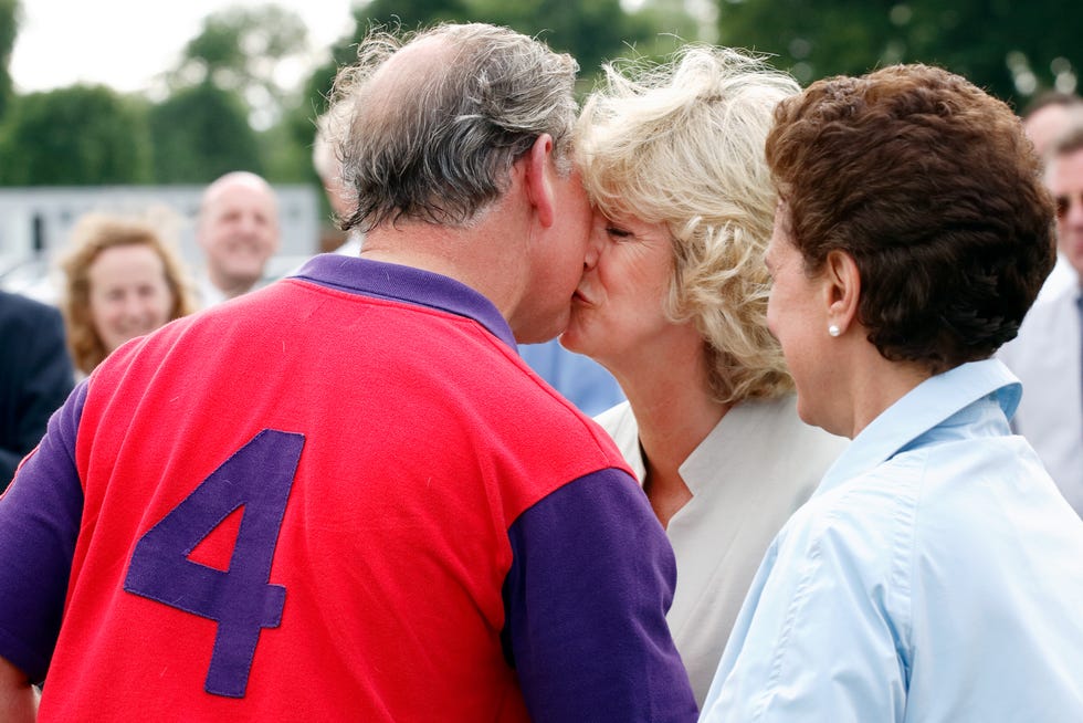 prince charles, prince of wales kisses camilla, duchess of cornwall as she presents him with his prize