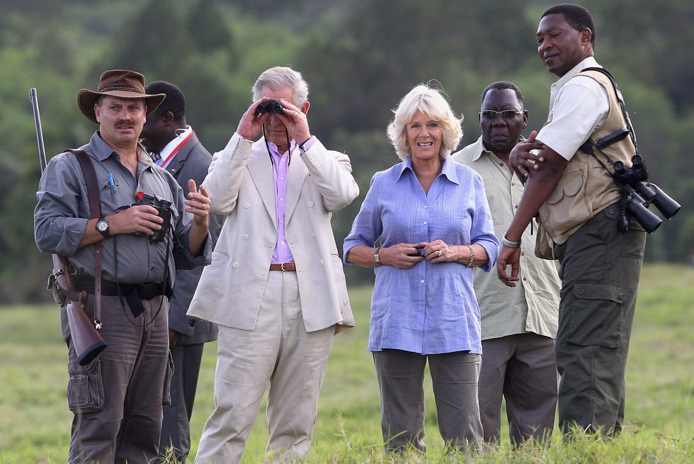 prince charles, prince of wales looks through binoculars beside camilla, duchess of cornwall