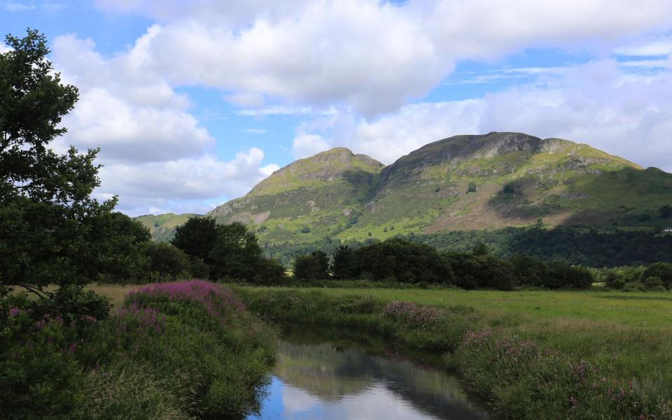 Dumyat Ochil Hills reflected in a river.