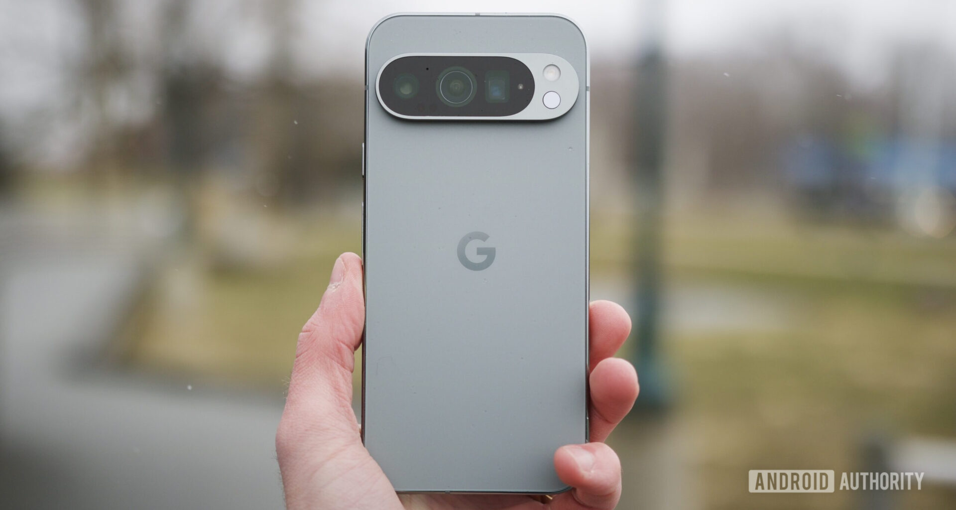 Someone holding the Google Pixel 9 Pro outside.