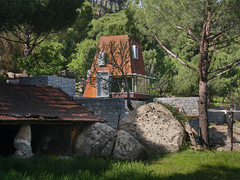 corten steel angular cabin emerges amongst pergamon forests in turkey