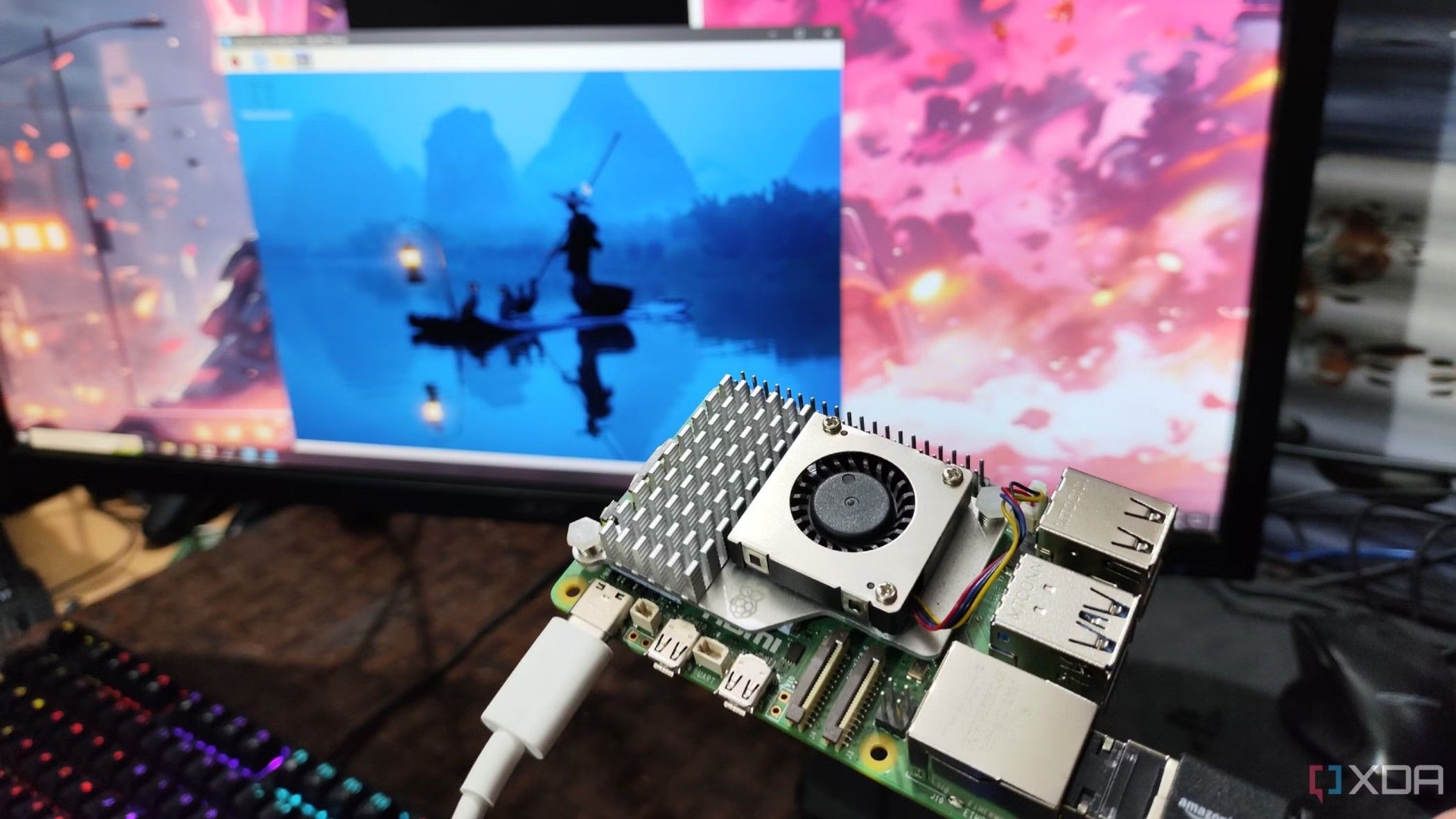 A photo of person holding a Raspberry Pi in front of a monitor