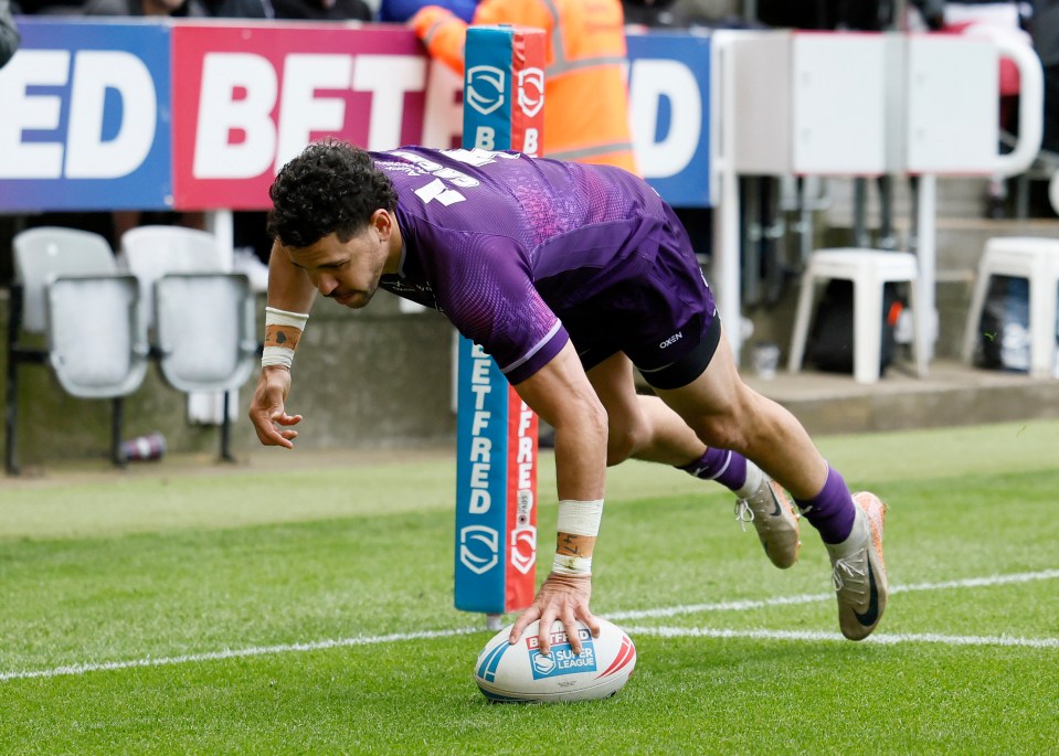 Jacob Gagai scoring a try in a rugby league match.