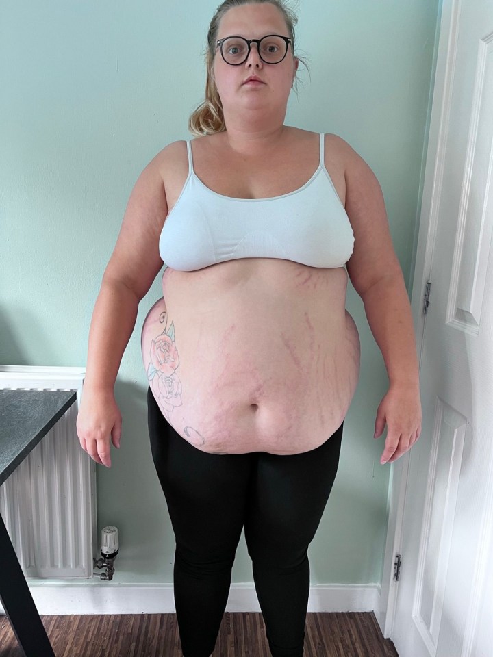 Woman in white bra and black leggings.