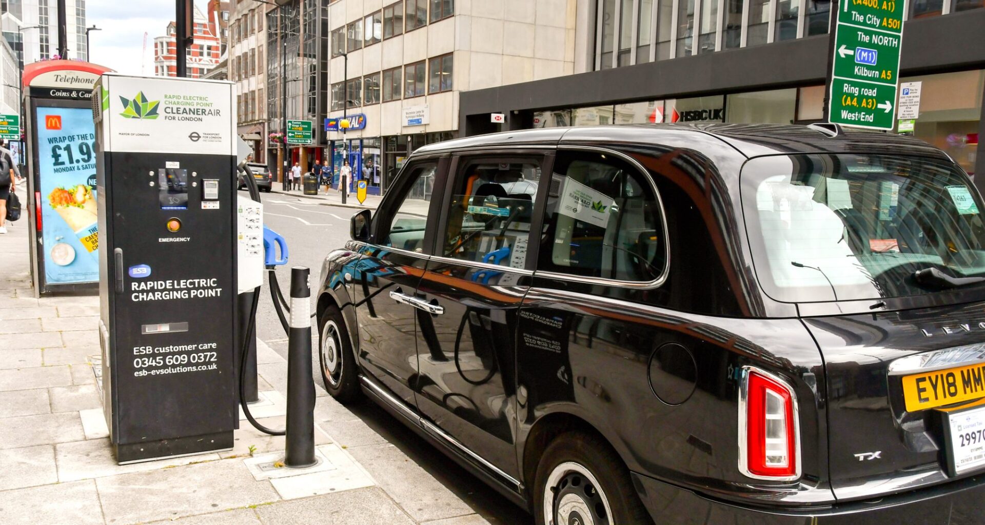 Electric London black cab connected to a rapid charging point in central London