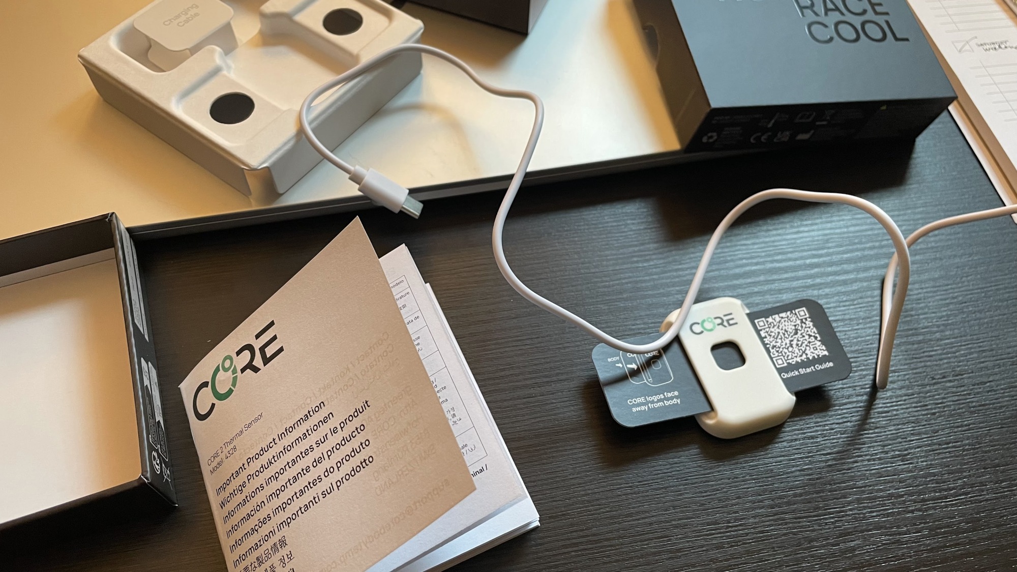 Core sensor unboxing; with charging cable, box, and packaging.