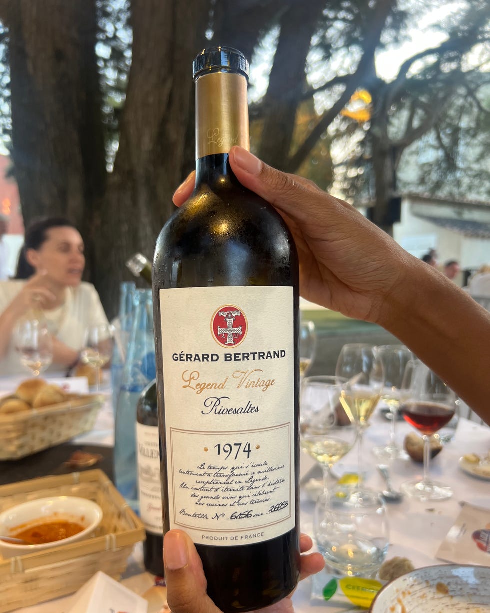a person holding a bottle of wine