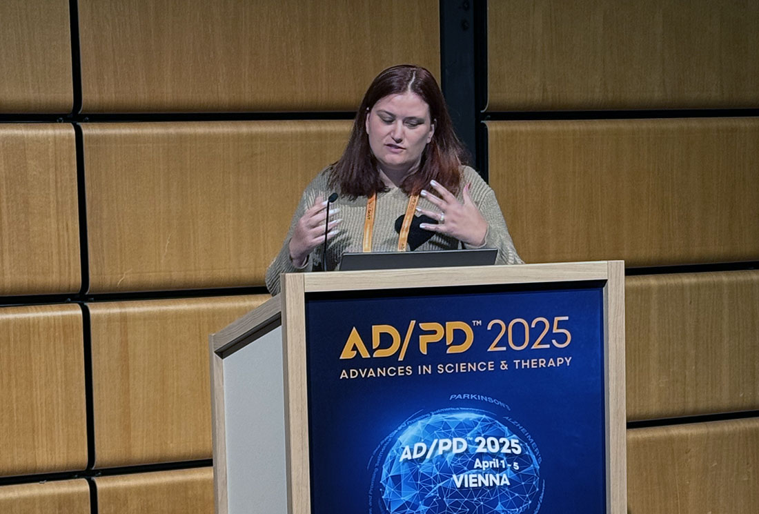 Dr. Karen Nuytemans speaking from a podium at the AD/PD meeting
