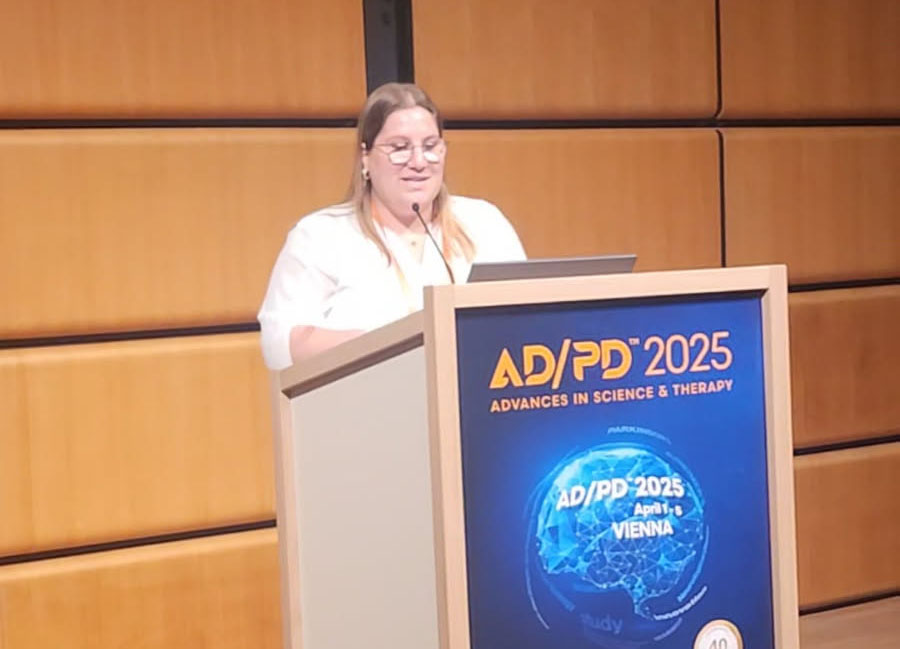 Dr. Sofia Moura speaking from the podium at the AD/PD meeting