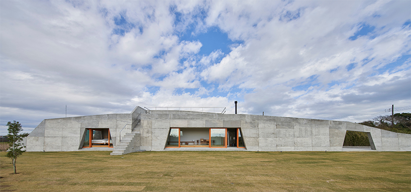 concrete isumi villa by takeshi hosaka architects organically spreads over land in japan