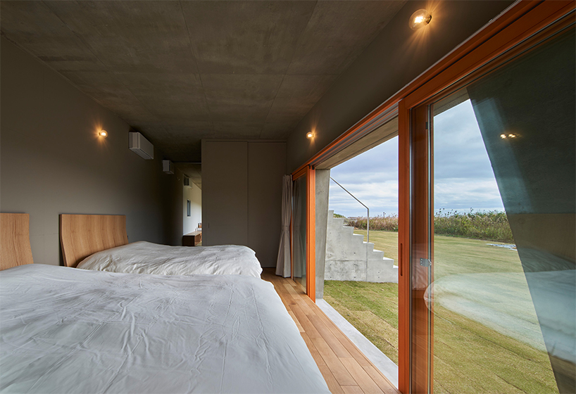 concrete isumi villa by takeshi hosaka architects organically spreads over land in japan