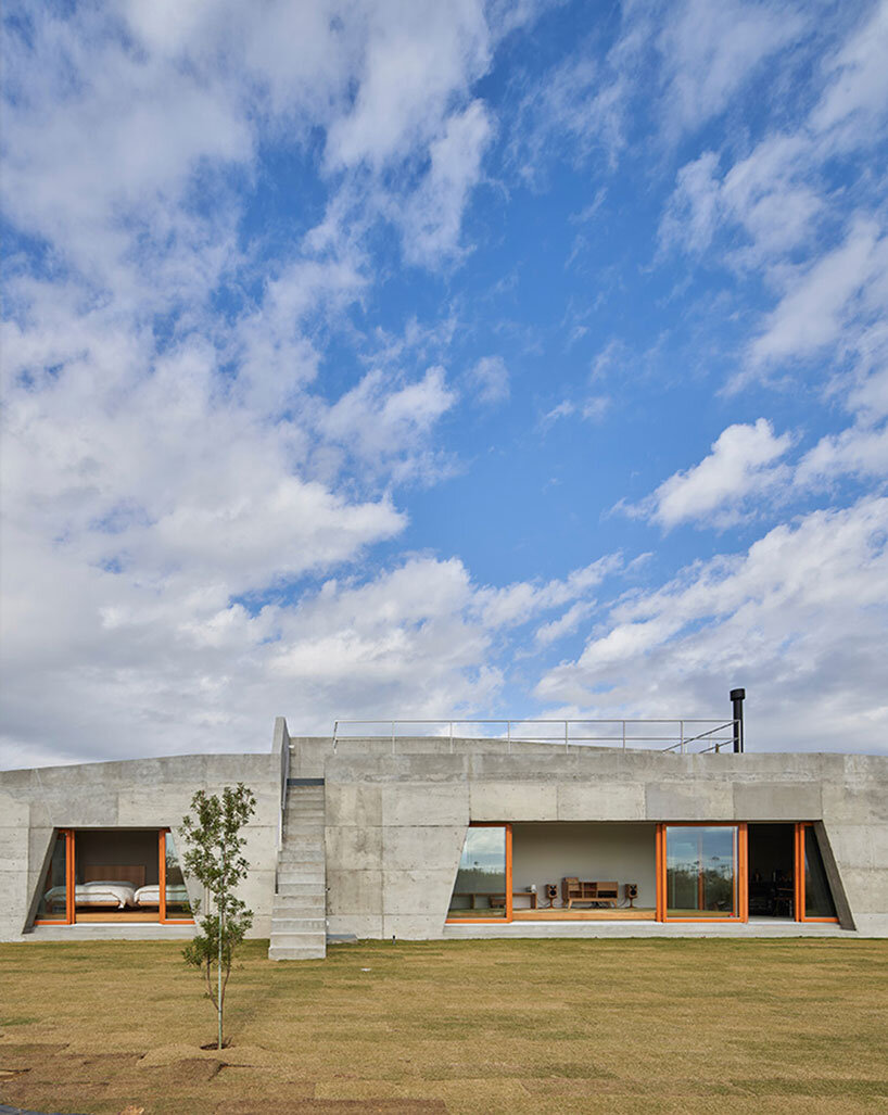 concrete isumi villa by takeshi hosaka architects organically spreads over land in japan